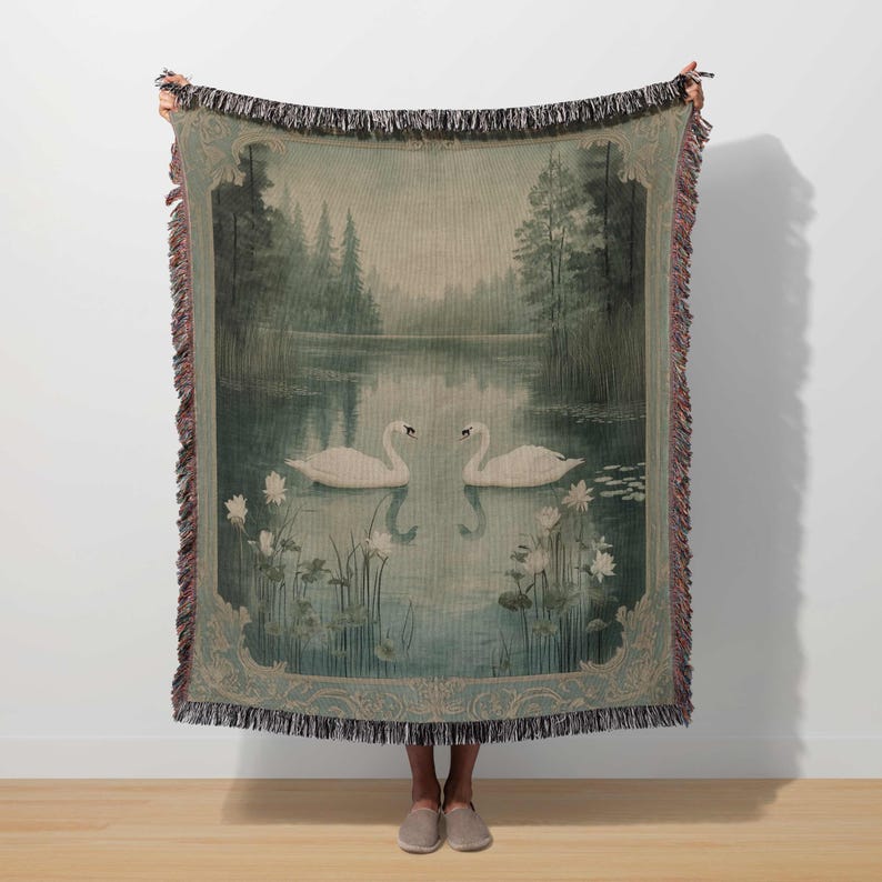 a woman holding a tapestry with swans on it