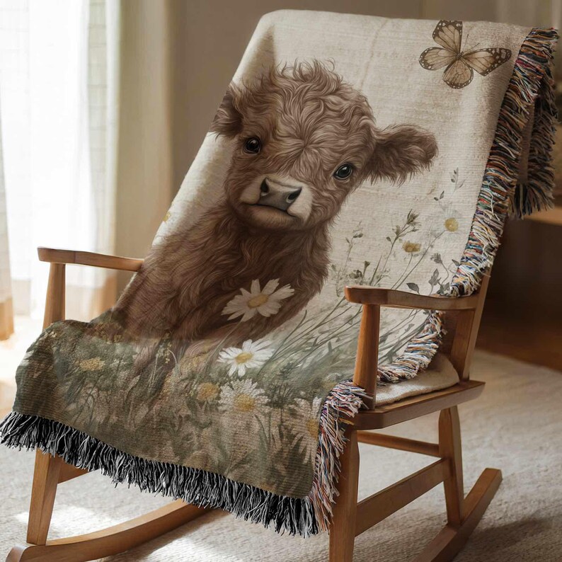 A brown cow with a flower on its back is sitting on a wooden rocking chair, which is covered with a blanket featuring a floral pattern.