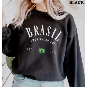 a woman wearing a black sweatshirt with the words brasil printed on it