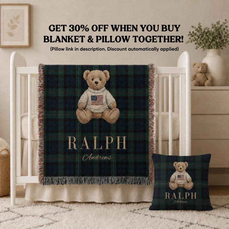 May include: A woven blanket and a square pillow featuring a dark green and navy blue plaid pattern. Both items display a brown teddy bear wearing a cream sweater with an American flag graphic, the name RALPH, and the name Andrews in script.