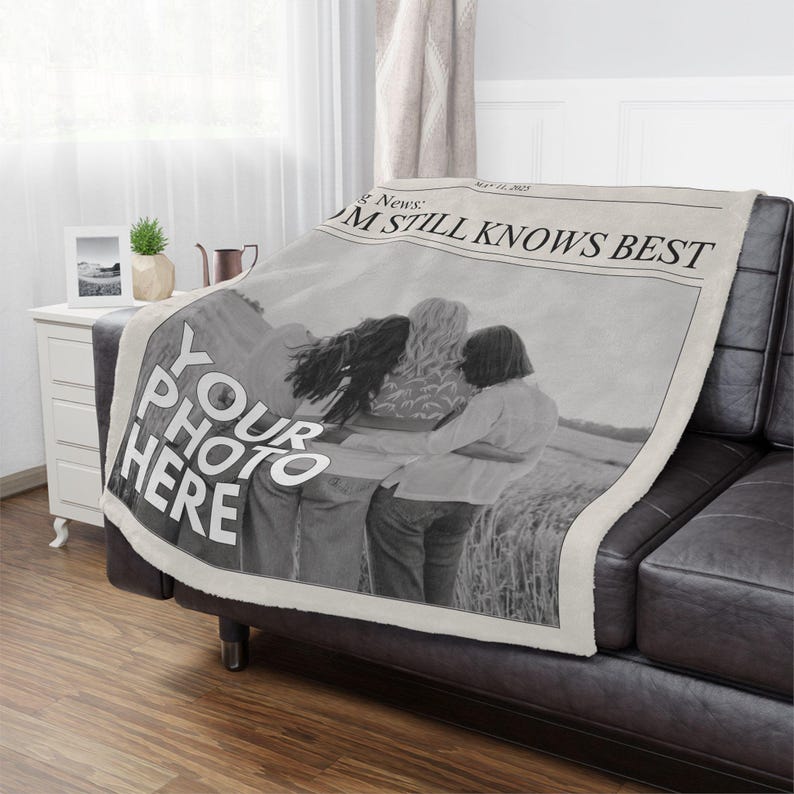 a black leather couch with a newspaper cover on it