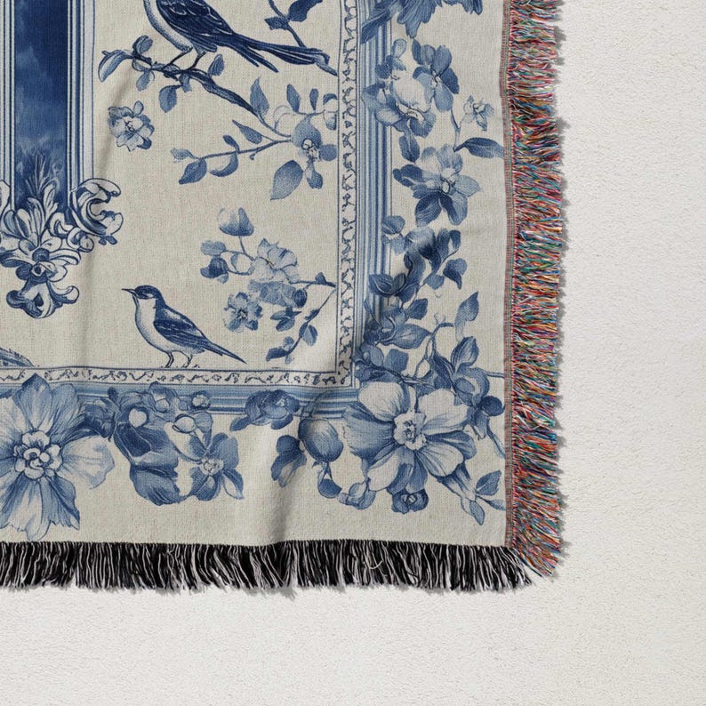 a blue and white scarf with a bird on it