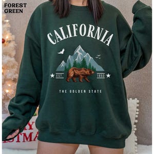 a woman wearing a sweatshirt with a bear on it