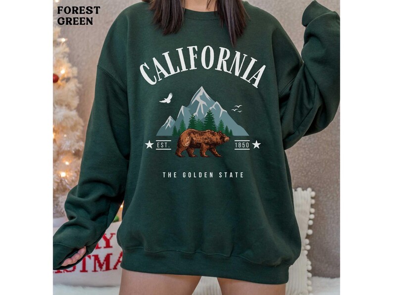 a woman wearing a sweatshirt with a bear on it