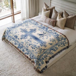 a bed with a blue and white comforter on top of it