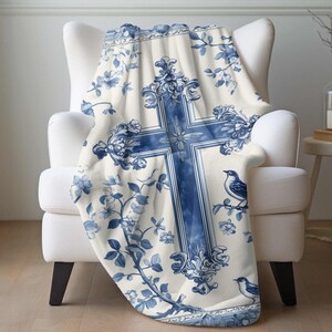 a blue and white blanket with a cross on it