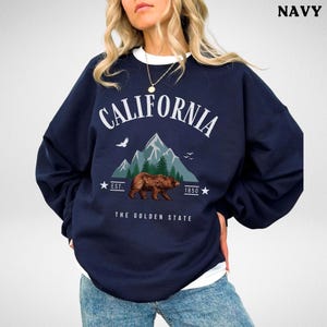 a woman wearing a sweatshirt with a bear on it