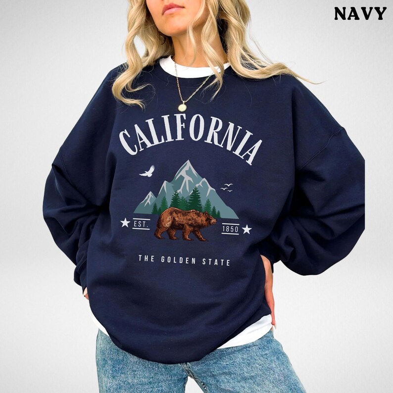 a woman wearing a sweatshirt with a bear on it