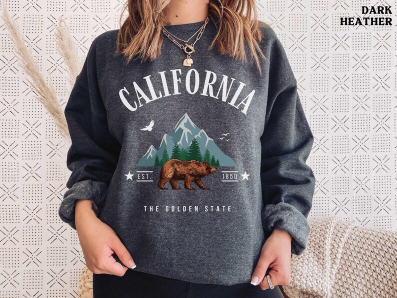 a woman wearing a sweatshirt with a bear on it