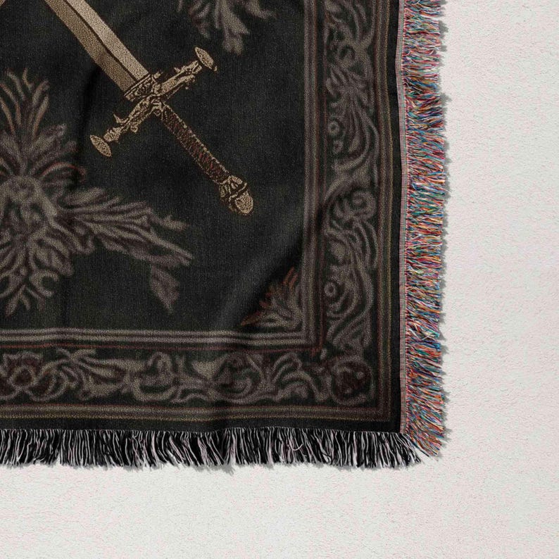 a close-up view of a decorative fabric with a sword design on it.