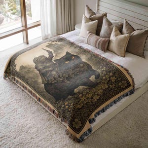 a large bed with a decorative blanket that depicts a black cat riding a horse. The bed is surrounded by pillows, and the overall scene has a cozy and inviting atmosphere.