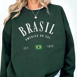a woman wearing a green sweatshirt with the words brasil on it