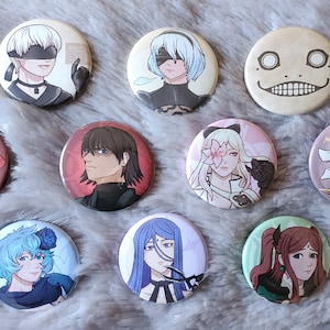 May include: Twelve round buttons with various characters and designs. The buttons feature a red dragon, a white dragon, a character with blue hair, a character with blonde hair, a character with black hair, a character with brown hair, a character with purple hair, a character with red hair, a character with yellow hair, a character with a blindfold, a character with a flower, and a character with a smile.