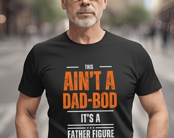 May include: A black t-shirt with the text "This ain't a dad-bod it's a father figure" in orange and white.