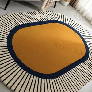 May include: A round rug with a mustard yellow center, a navy blue border, and a cream-colored outer edge with black vertical stripes. The rug has the text "ILLUSI RUG" on it.