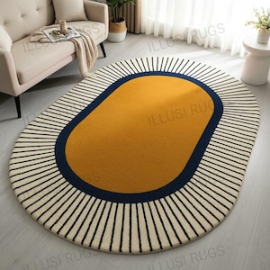 May include: Oval area rug with a mustard yellow center, a navy blue border, and a cream-colored background with black vertical stripes. The rug is a modern home decor item.