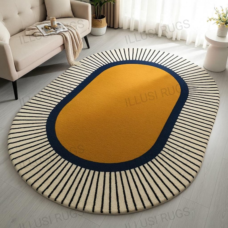 May include: Oval area rug with a mustard yellow center, a navy blue border, and a cream-colored background with black vertical stripes. The rug is a modern home decor item.
