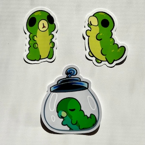 May include: Three green cartoon caterpillar stickers. One caterpillar is standing upright, another is curled up in a jar, and the third is standing upright with its arms raised.