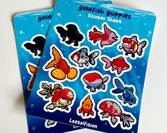 May include: A sticker sheet featuring goldfish and guppies in various colors and poses. The sheet is titled "Goldfish Guppies Sticker Sheet" and has the text "LostxVision" at the bottom.