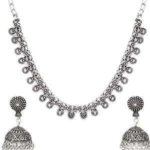 May include: A silver-toned necklace and earring set. The necklace features a chain with circular and teardrop-shaped accents. The earrings are bell-shaped with intricate patterns and a circular top. The jewelry set is displayed against a white background.