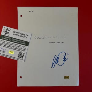 May include: A white document featuring the typed text "Enjoy yourself -- every day above ground is a good day." and "ANONYMOUS, MIAMI 1981" with a blue ink signature and a London Autograph Registry certificate of authenticity with a QR code.