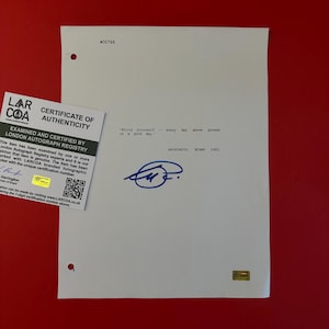 May include: A white document featuring the typed text 'Enjoy yourself -- every day above ground is a good day.' and 'ANONYMOUS, MIAMI 1981' with a blue ink signature below. A square white Certificate of Authenticity from LARCOA is attached.