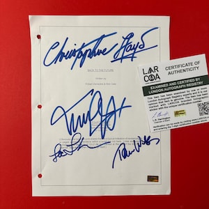 May include: A white script page for Back to the Future, written by Robert Zemeckis and Bob Gale, featuring three blue ink signatures. A white LARCOA Certificate of Authenticity card with black text and a QR code is placed on the right side.