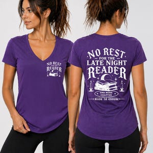 May include: A purple V-neck t-shirt with the text "NO REST FOR THE READER" on the front and "NO REST FOR THE LATE NIGHT READER" on the back. The back graphic includes books, candles, and the phrase "ONE MORE CHAPTER MADE TO ENDURE".