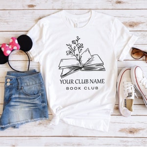 a t - shirt with a book and a minnie mouse ears