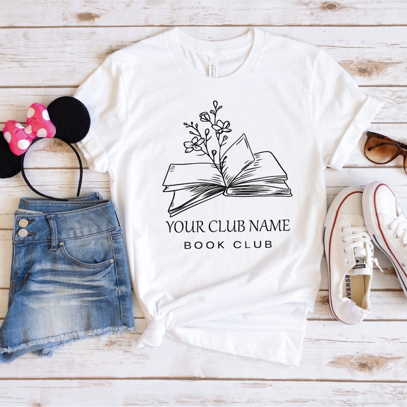 a t - shirt with a book and a minnie mouse ears