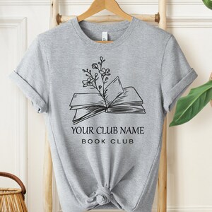 a t - shirt with an open book and a plant on it