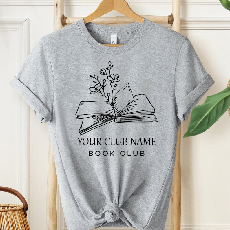 a t - shirt with an open book and a plant on it