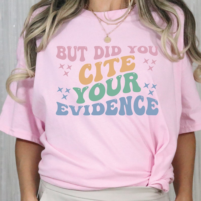 a woman wearing a pink shirt that says, but did you cite your evidence?