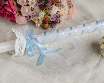 Baptism or communion candle with a blue ribbon, hand-decorated candle