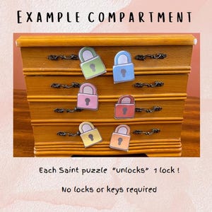 May include: A wooden dresser with five drawers, each with a different colored padlock on it. The text "Each Saint puzzle "unlocks" 1 lock!" and "No locks or keys required" is printed below the dresser.