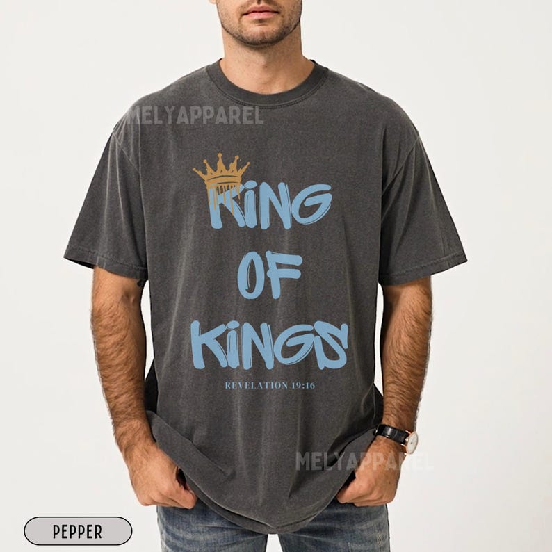 May include: A black t-shirt with a graphic print of a crown and the text "King of Kings" in blue and gold. The text "Revelation 19:16" is printed below the graphic.
