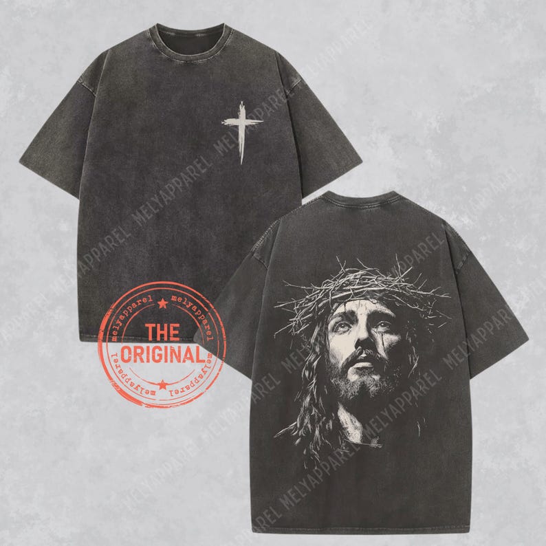 May include: Dark gray t-shirts with a distressed look. One shirt features a white cross on the front, the other a detailed image of Jesus wearing a crown of thorns. The shirts have a vintage style.