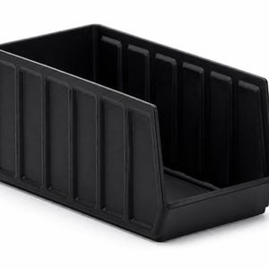 May include: A black storage bin with a rectangular shape and a sloped front. The bin has vertical ridges on the sides and is made of a solid, matte material. It is designed for organizing and storing items.