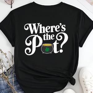 May include: Black t-shirt with white text that reads "Where's the Pot?" and a graphic of a pot of gold with a shamrock.