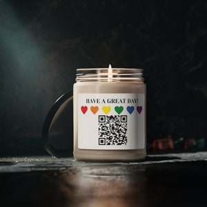 May include: A beige candle with a white label that says "HAVE A GREAT DAY!" and features a rainbow of hearts and a QR code.