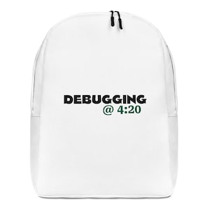 May include: White backpack with black zippers and the text "DEBUGGING @ 4:20" in black and green. The backpack has a rounded top and a front pocket.