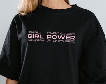 May include: Black t-shirt with a pink "GIRL POWER" graphic printed on the front.