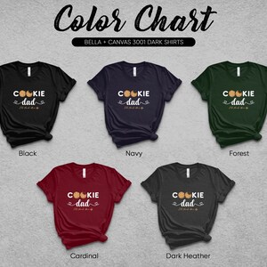 May include: A color chart showing different Bella + Canvas 3001 dark t-shirt colors. The shirts feature a graphic that says "Cookie Dad" with a cookie design. The colors shown are black, navy, forest, cardinal, and dark heather.