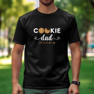 May include: Black t-shirt with a white graphic that says "Cookie Dad" with two cookie images and the text "I'll think you up".