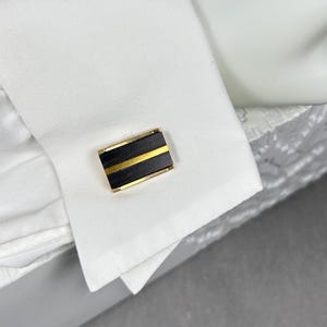 Vintage rectangular gold-colored unisex cufflinks with black/stained wood inserts from the 1960s.
