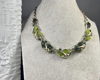 Vintage LISNER green and gold 7-piece choker necklace with plastic and crystal inserts.