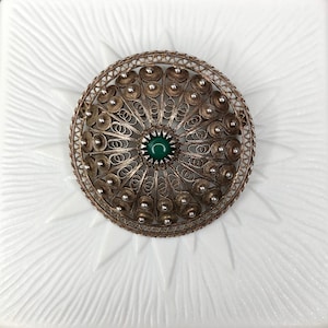 Antique silver filigree brooch from Genoa with a small green cabochon