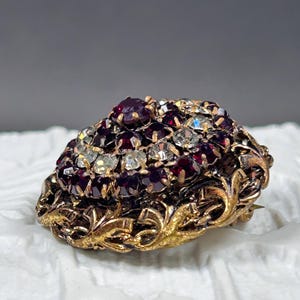 Vintage Czechoslovakian openwork garnet glass and lead crystal brooch from the 1950s.
