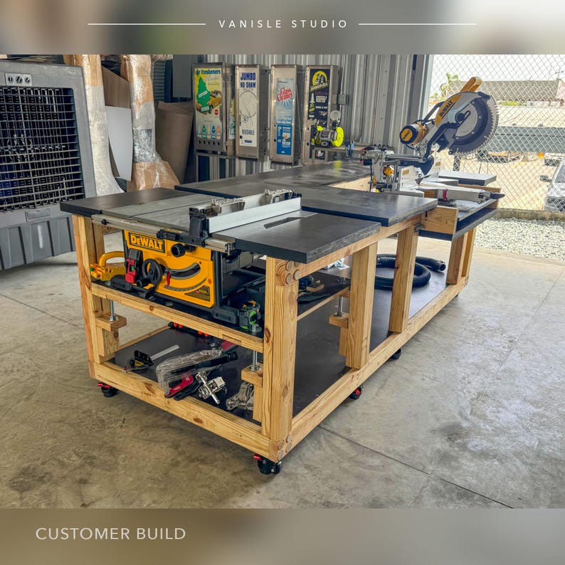 May include: A custom-built wooden workbench on castors featuring a yellow and black DeWalt table saw integrated into the surface, with a mitre saw mounted on the extended side. The structure includes a lower shelf for tool storage and a dark top.