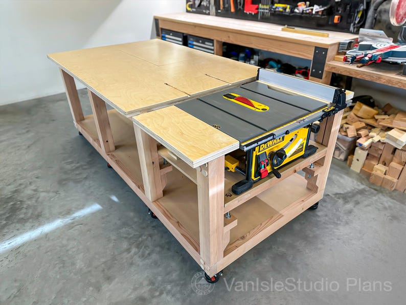 May include: A large wooden workbench with a built-in yellow and black DEWALT table saw. The workbench has a light wood finish and is on wheels. The saw has a red and yellow blade guard. The workbench is designed for woodworking.